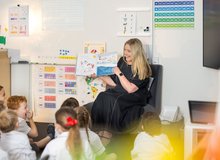 A teacher reading to students in a classroom