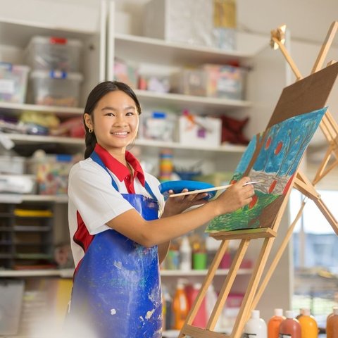 A student painting an artwork.
