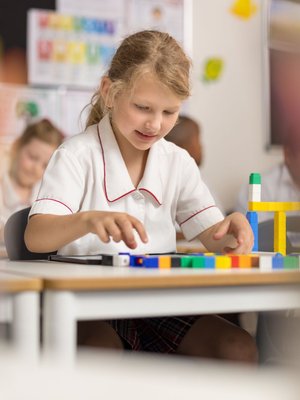 A young student working in a classroom.