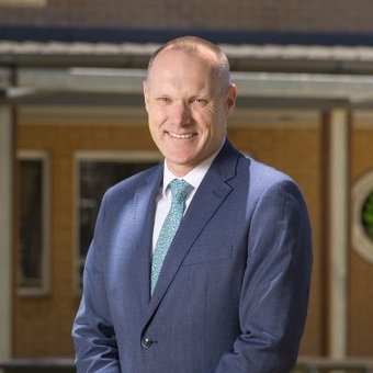 School Principal Mr Darren Hutton smiling.